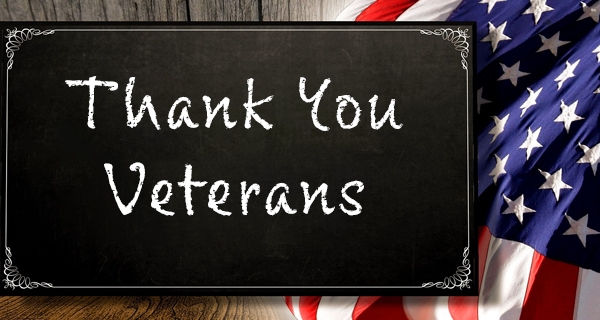 A chalkboard sign says Thank You Veterans