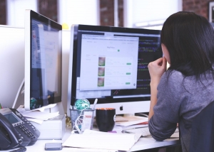 photo - woman looking at a computer screen