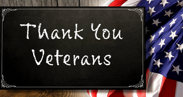 A chalkboard sign says Thank You Veterans